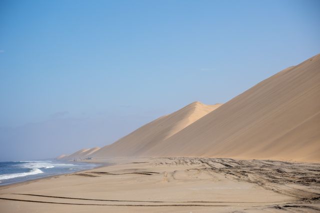 Group tour vehicles at the Namib dunes